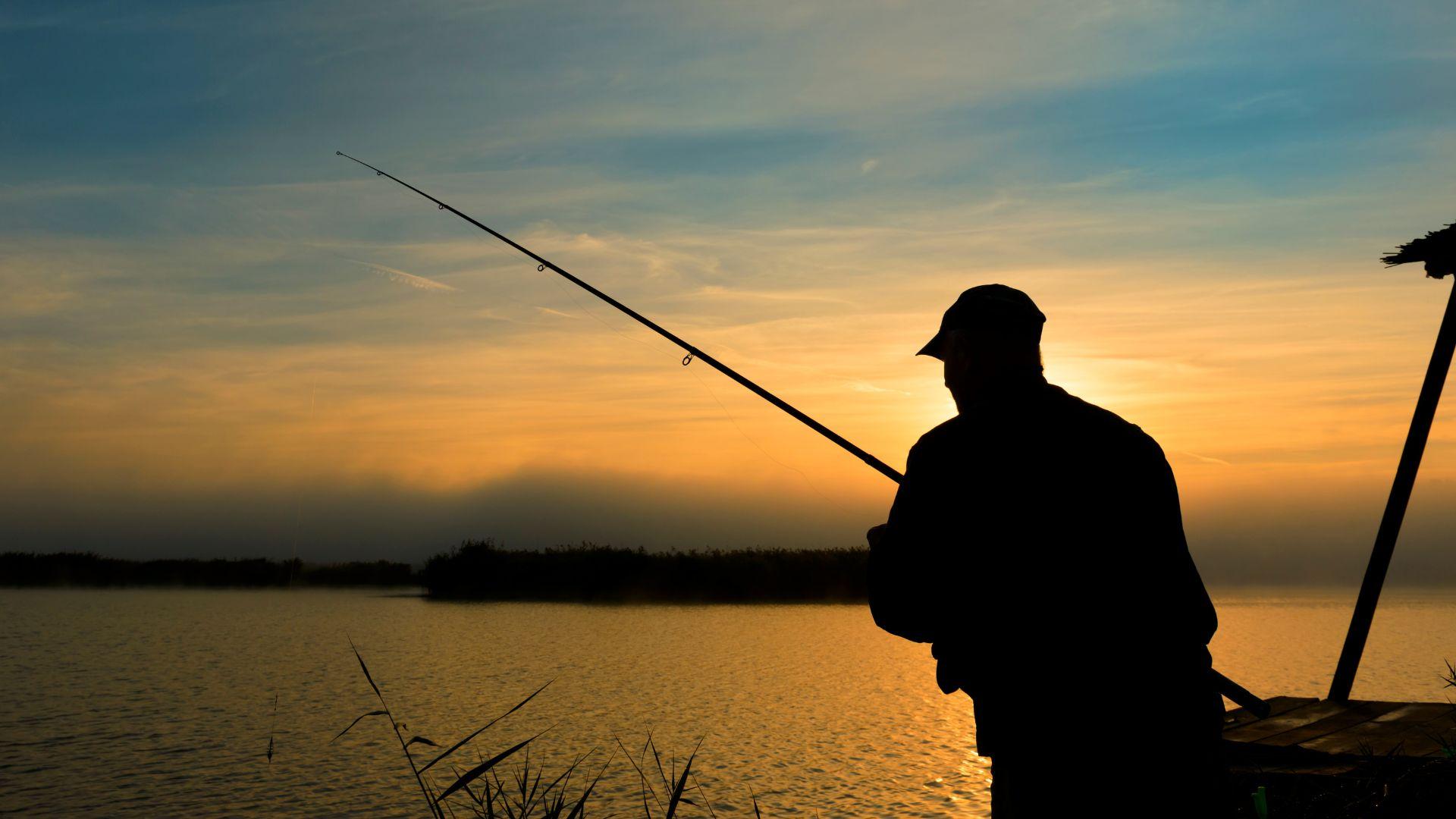 A man fishing at dusk