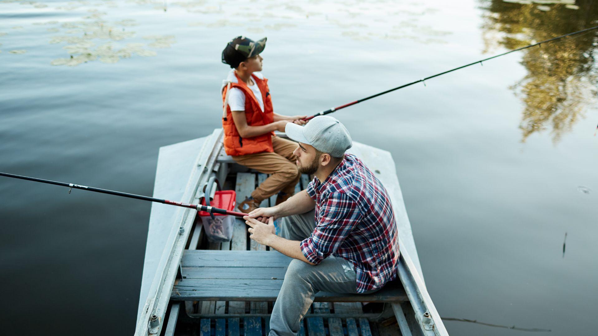Two people on a boat fishing